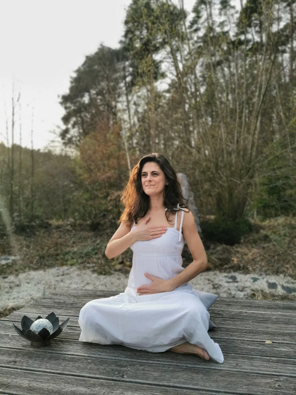 Andreea Burlacu in Meditation, die Hand auf dem Herzen