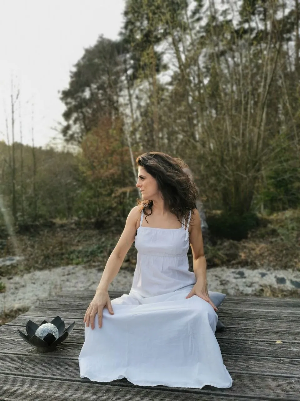 Andreea Myriel Burlacu im weißen Kleid auf dem Holzdeck